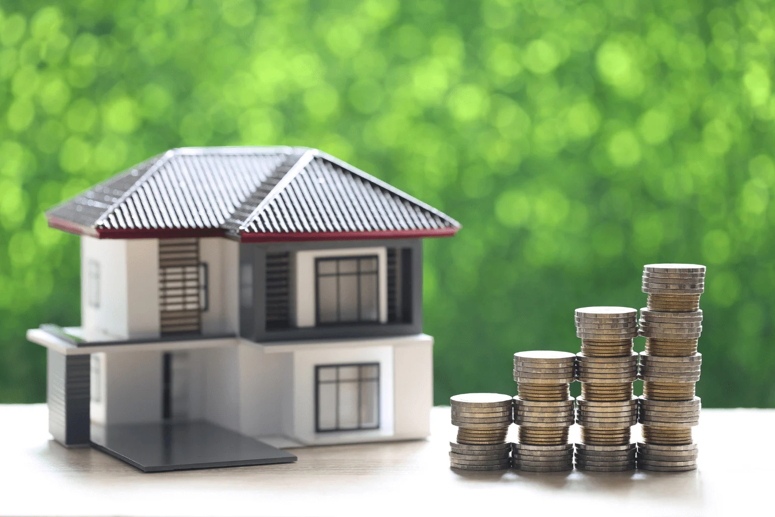 First-Time Homebuyer Mistakes stack of coins and a house model