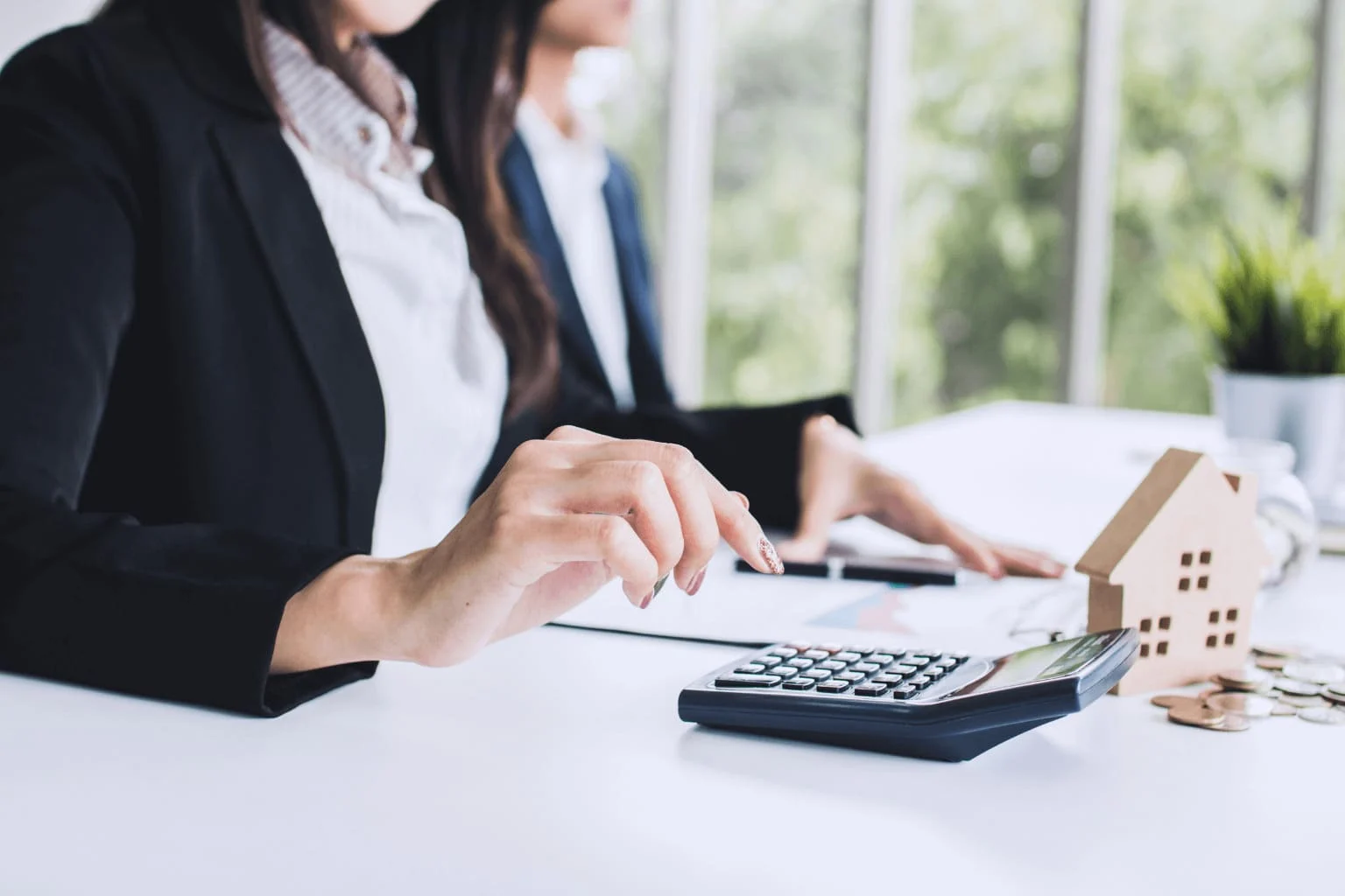 Common First-Time Homebuyer Mistakes in Walnut Creek Calculator, house key, and paperwork on a table showing home buying costs
