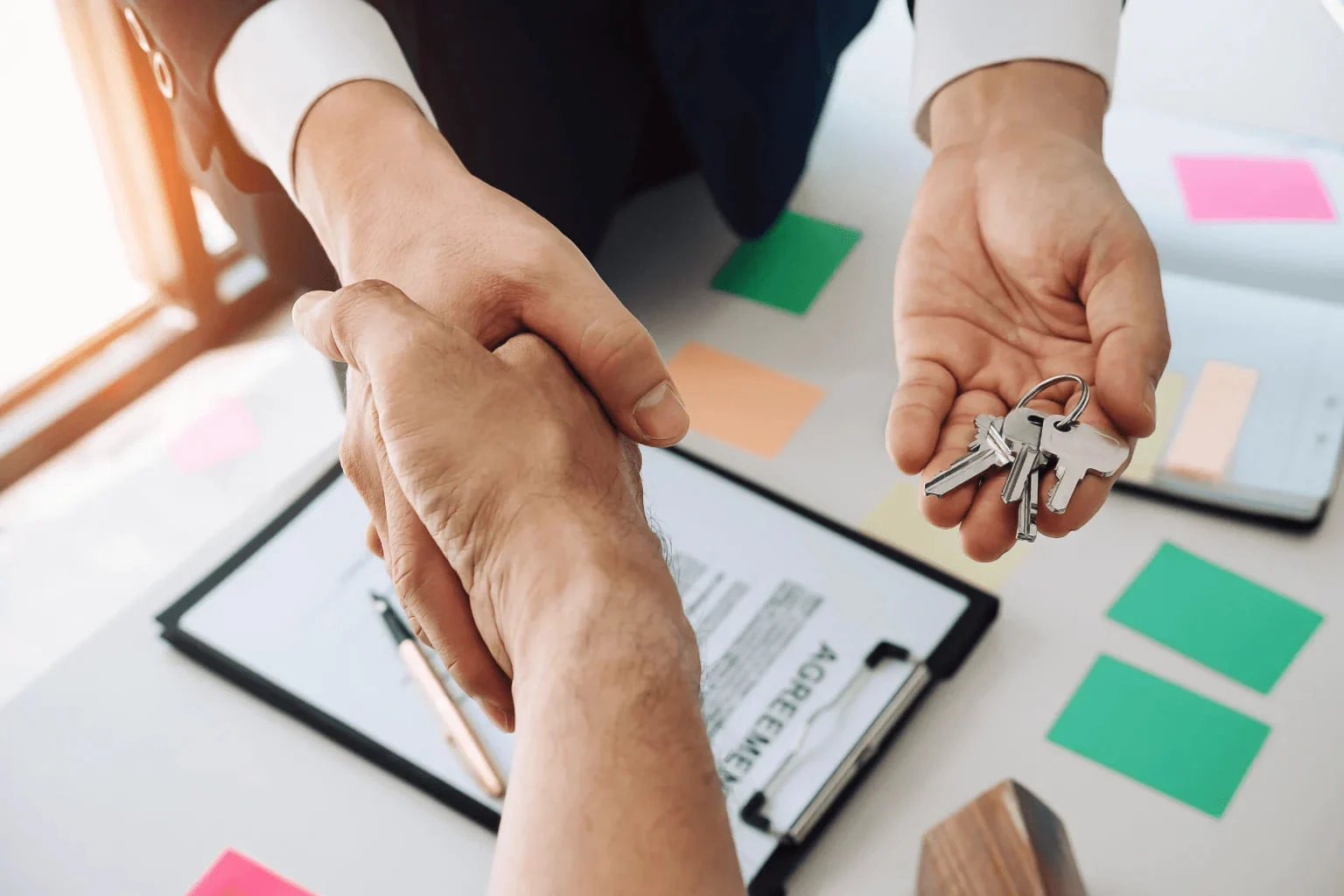 Day In The Life Of A Real Estate Agent people shaking hands and giving a key